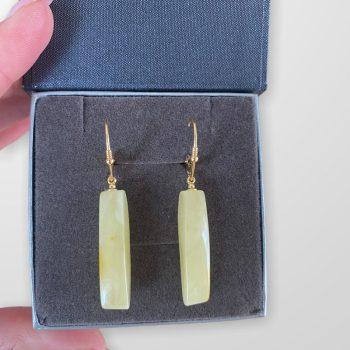 Oblong yellow amber earrings cut from a single piece