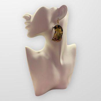 Distinctive butterfly-shaped light yellow amber earrings with darker threads and black patterns