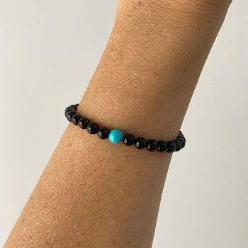 Stylish bracelet of perfect glossy black amber balls with agate stone detail