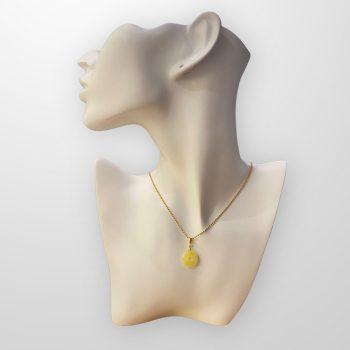 Fine round amber amulet in shades of yellow