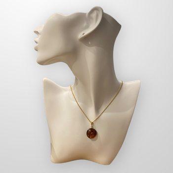Fine round cherry amber amulet