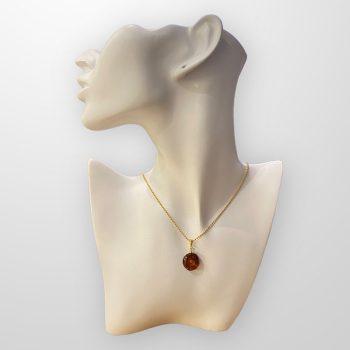 Stylish round cherry amber amulet