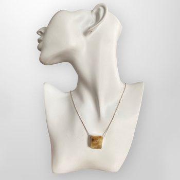 Elegant elk horn and yellow amber neck pendant in an irregular square shape