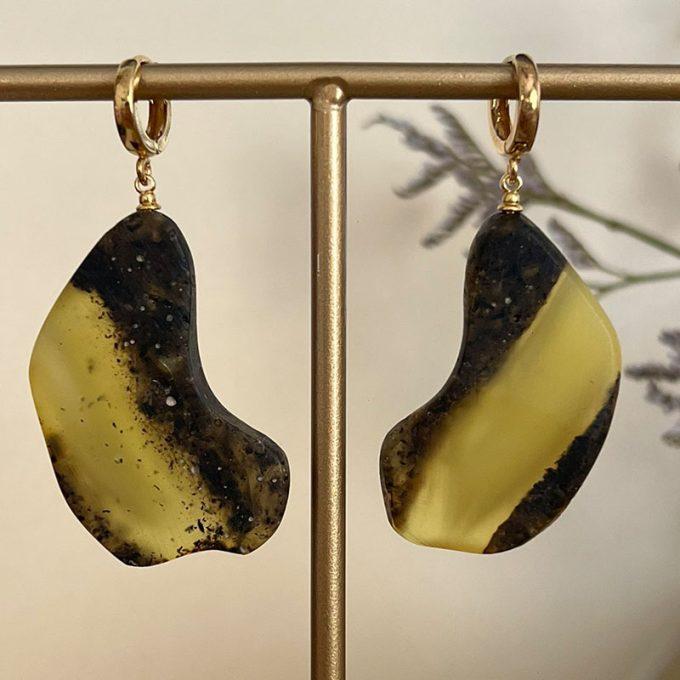 Chunky matt cut amber earrings in curved round shapes