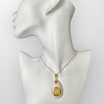 Sophisticated and delicate oval elk antler neck pendant with encrusted yellowish amber detail