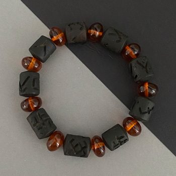 Men's amber bracelet with engraved black oak details and honey coloured discs