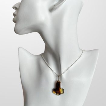 Fine Viking axe-shaped amber neck pendant in dark shades