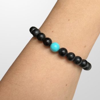 Youthful bracelet of matt black amber bubbles with a blue bubble in the centre