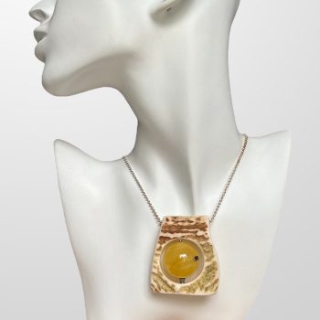 Luxurious elk antler pendant with amber detail rotating on its axis