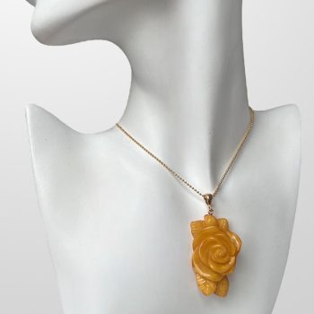 Expressive engraved rose-shaped neck pendant in rich yellow amber