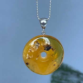 Delicate clear yellow amber amulet
