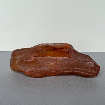 Transparent yellow amber piece with natural bark