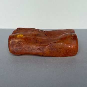 Transparent amber piece with natural bark