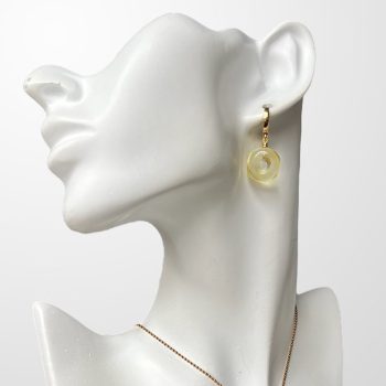 Delicate set of clear amber earrings and pendant in the shape of an amulet