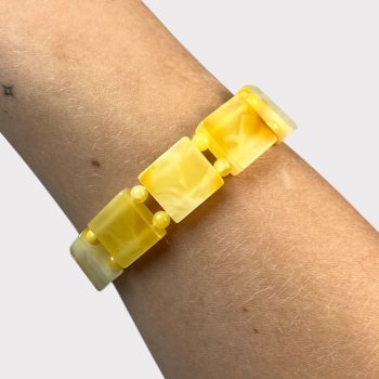 Playful bracelet with yellow amber tiles and balls