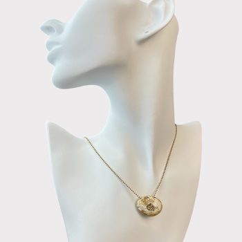 Chic speckled amber neck pendant with decorated hole in the centre