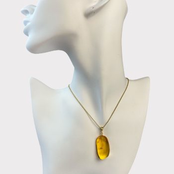 Delicate clear amber pendant with inlays