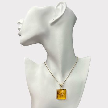 Charming clear amber pendant with inlays