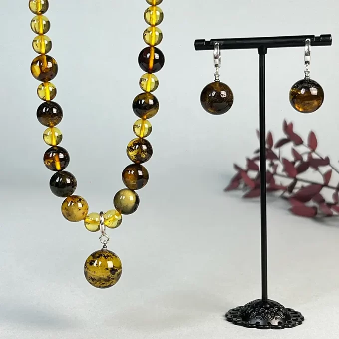 Refined set of clear and moss amber earrings and necklace with pendant