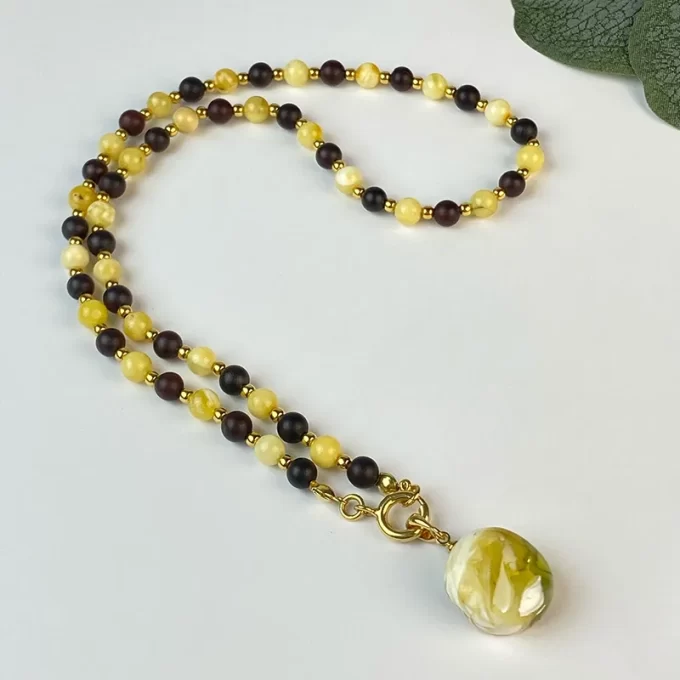 Fine two-tone amber necklace with landscape amber pendant