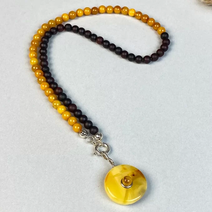 Fine amber bead necklace with pendant with ant inlay