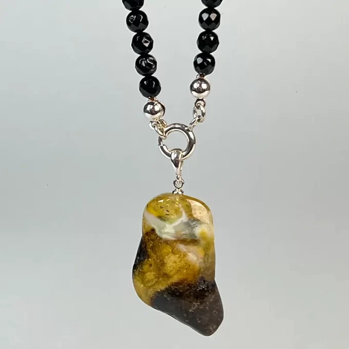 Enchanting black faceted amber necklace with amber landscape pendant