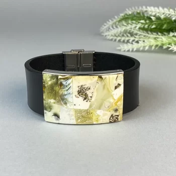 Fashionable black leather bracelet with landscape amber detail
