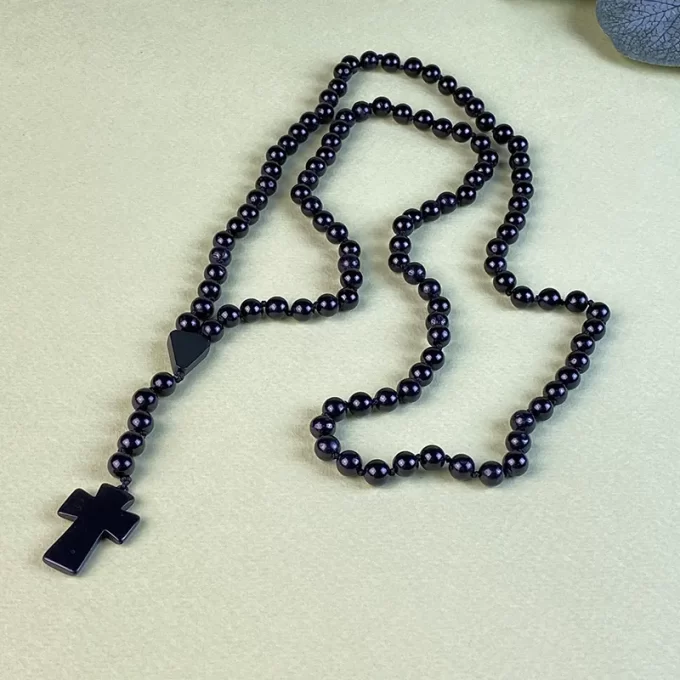 Fashionable men's necklace in black amber beads with cross pendant