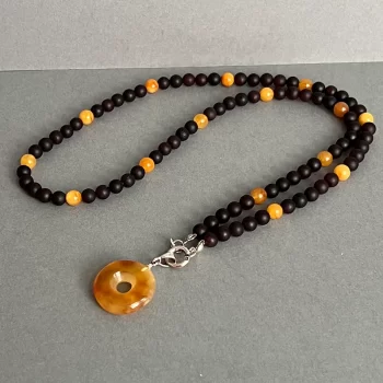 Stunning black and light amber bead necklace with charm pendant