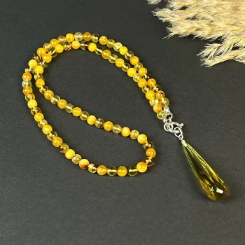 Stunning clear and caramel amber bead necklace with pendant with inlay