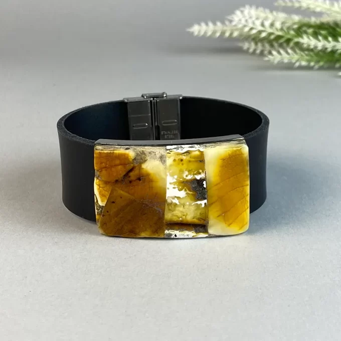 Stylish black leather bracelet with speckled amber detail