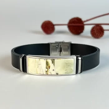 Stylish black men's leather bracelet with greenish landscape amber detail