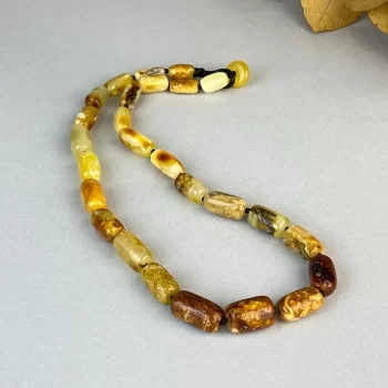 Dainty necklace of glossy speckled amber baubles 2