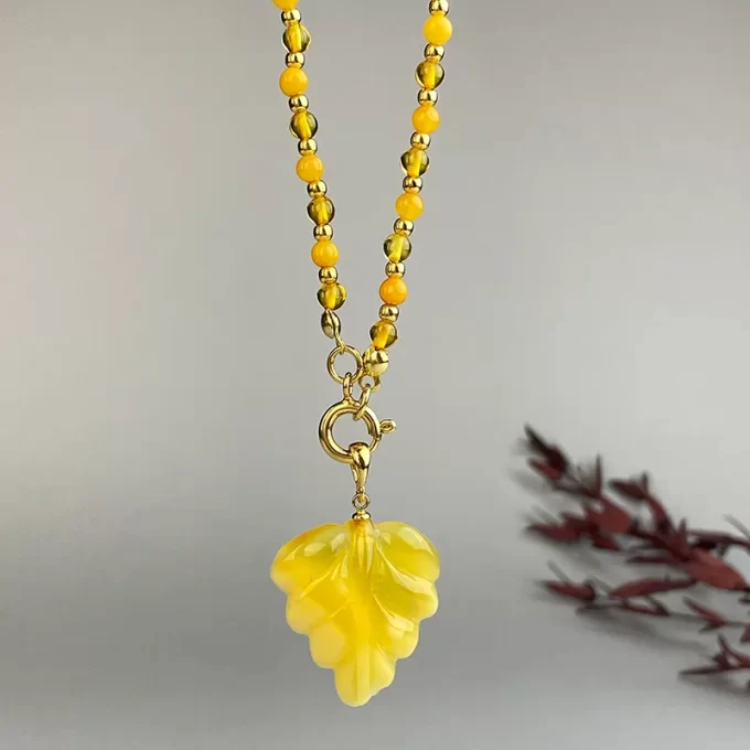 Fine clear and caramel amber bead necklace with engraved pendant