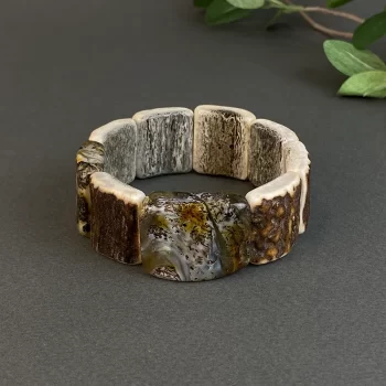 Beautiful bracelet with engraved elk horn and amber with bluish details