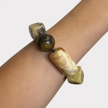 Beautiful bracelet with light and dark speckled amber details in various shapes 2