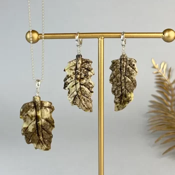 Fine set of engraved speckled amber earrings and pendant