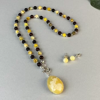 Fine set of black matt and shiny speckled amber necklace with pendant and earrings