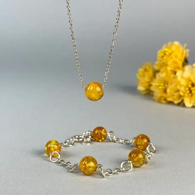 Fine honey coloured amber bracelet and pendant set