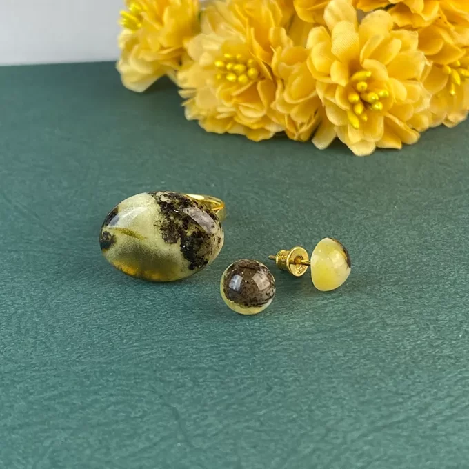 Fine set of greenish speckled amber ring and earring tacks