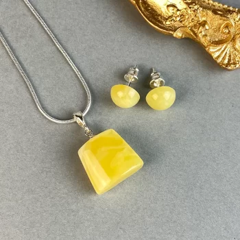Delicate set of landscape amber earring pins and necklace pendant